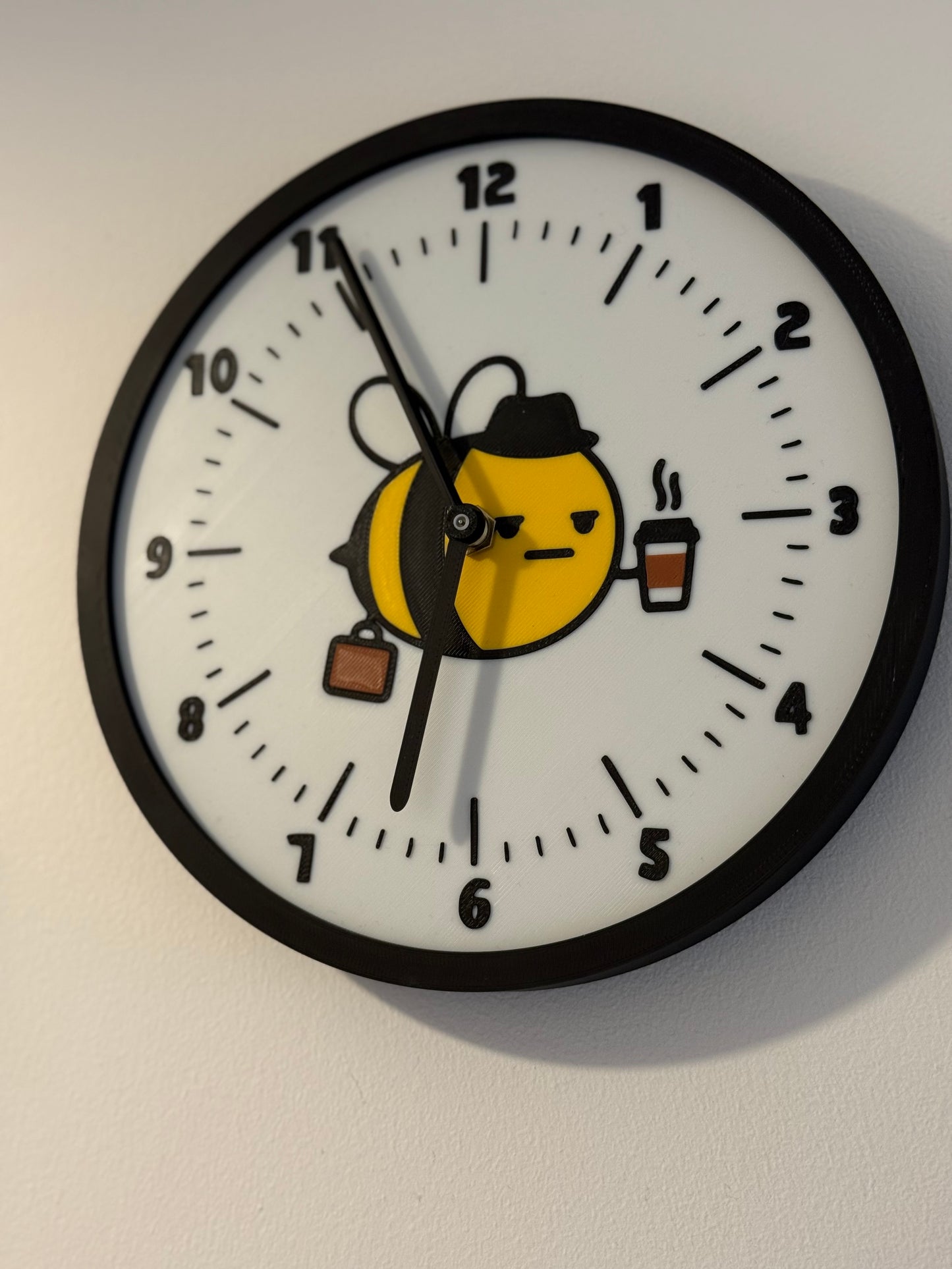 Not Made For This Wall clock with cartoon bee design on a white wall