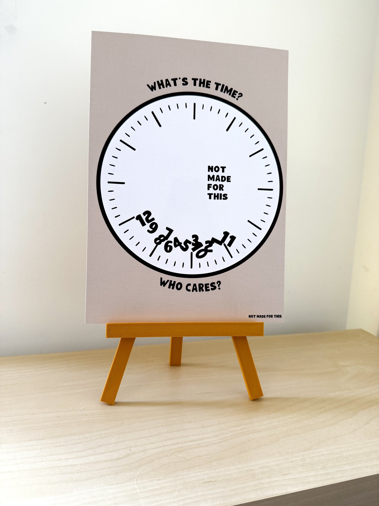 Poster with a clock design on an easel against a white wall
