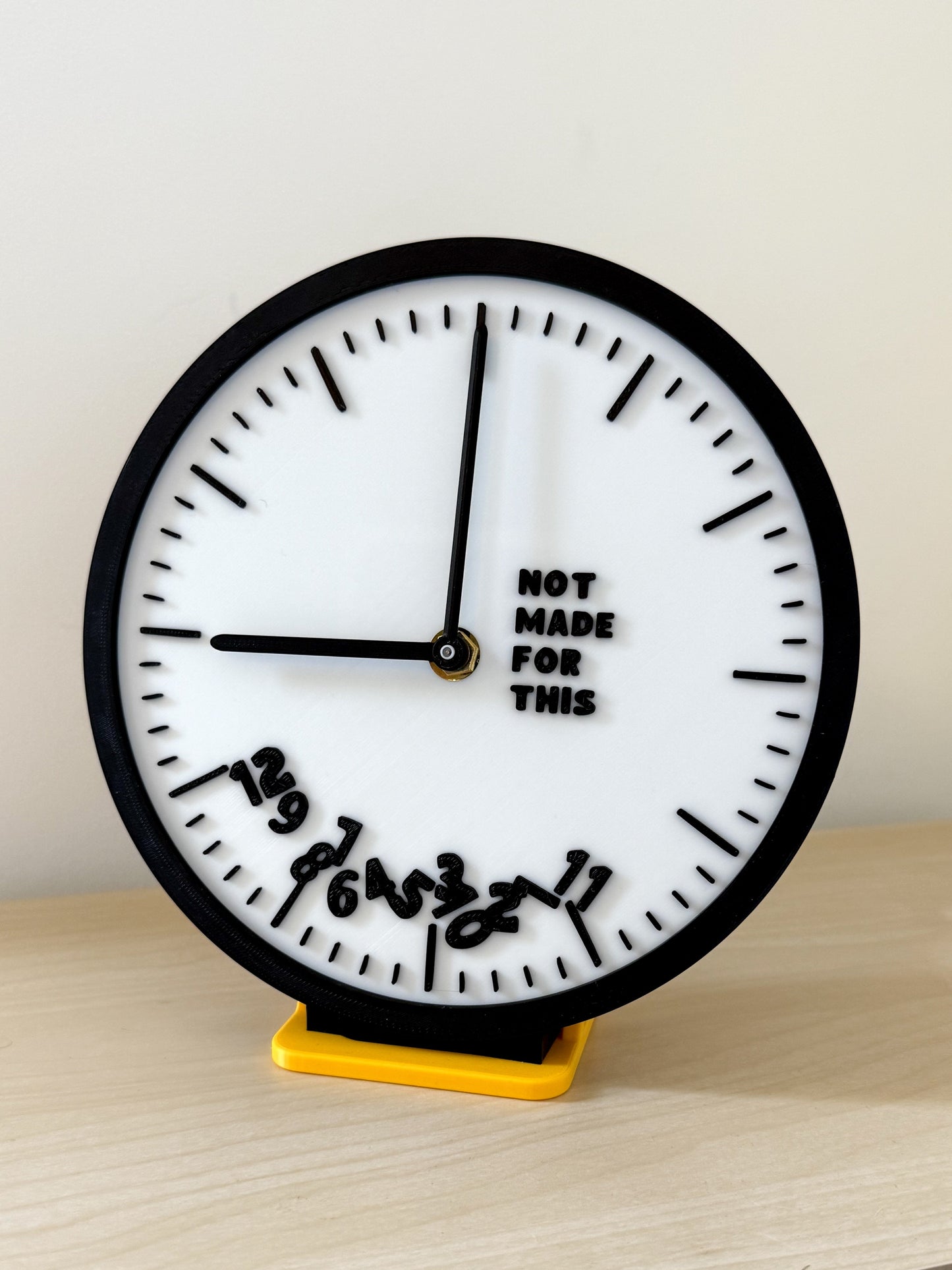 Not Made For This branded clock with all the numbers fallen to the bottom
