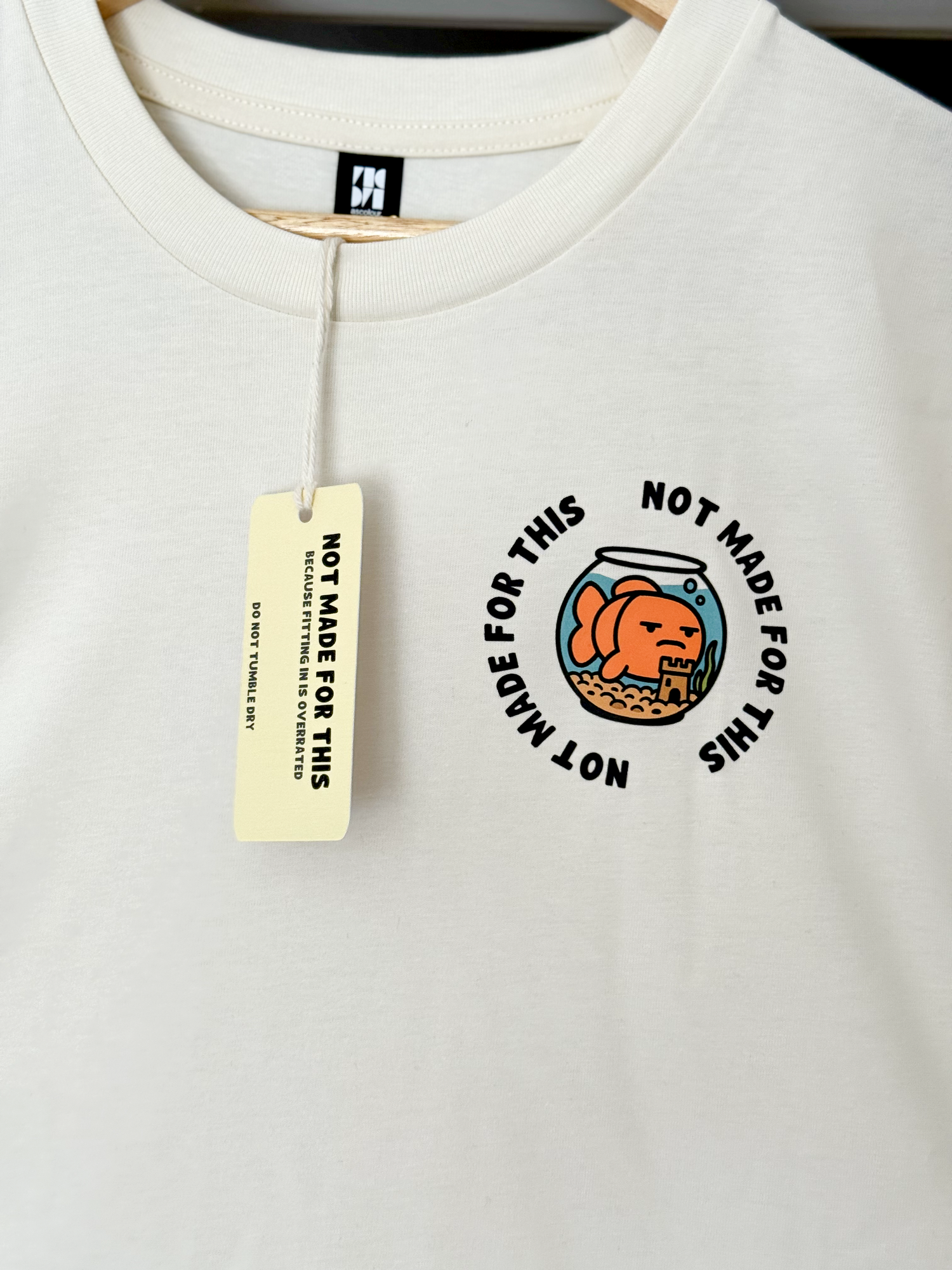White sweatshirt with 'Not Made for This' tag and graphic on a white background