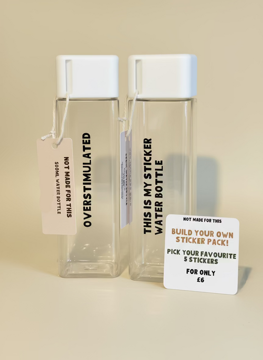Two clear water bottles with labels on a wooden surface