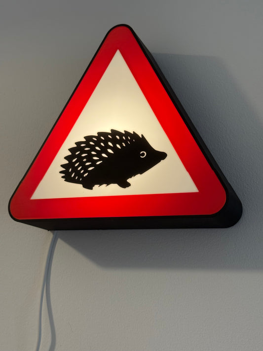 Hedgehog warning sign on a gray wall made by Not Made For This